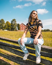 a woman sitting on a fence